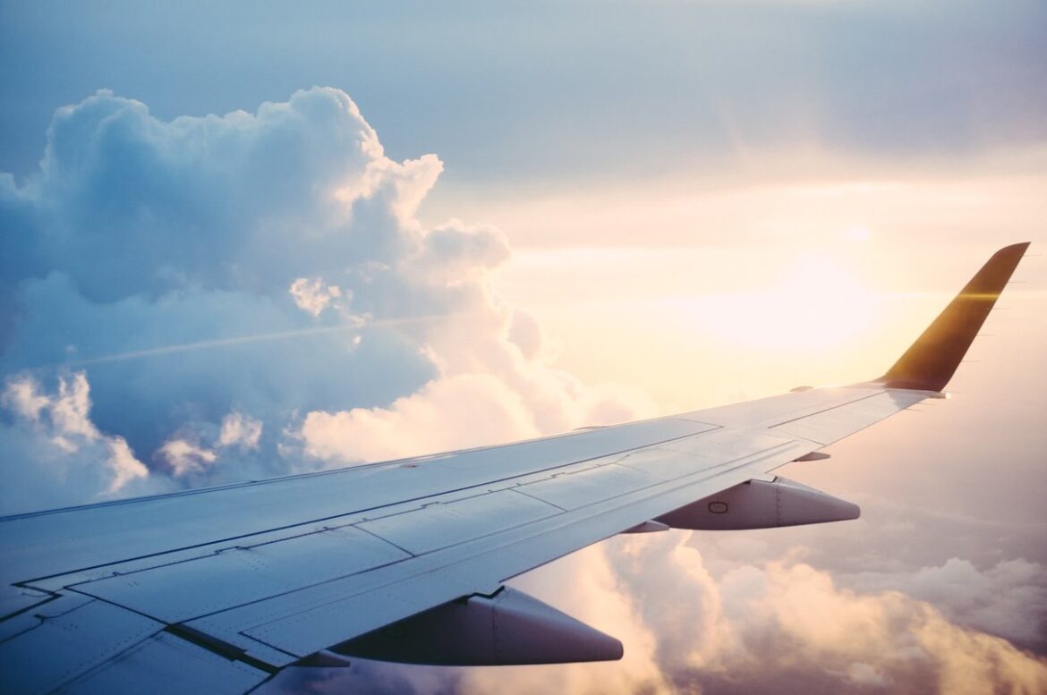 Airplane wing above clouds during a flight