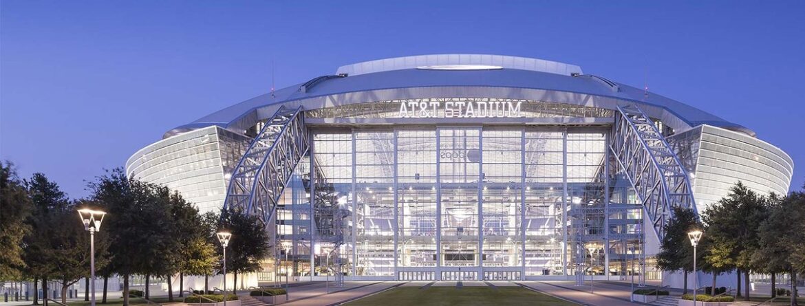 AT&T Stadium exterior glowing at night