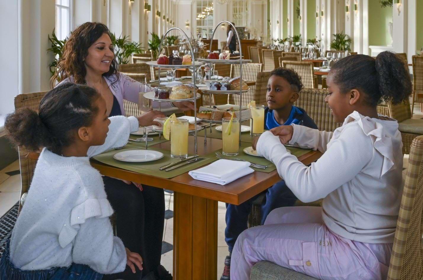 Adults and children enjoying afternoon tea at Blenheim Palace