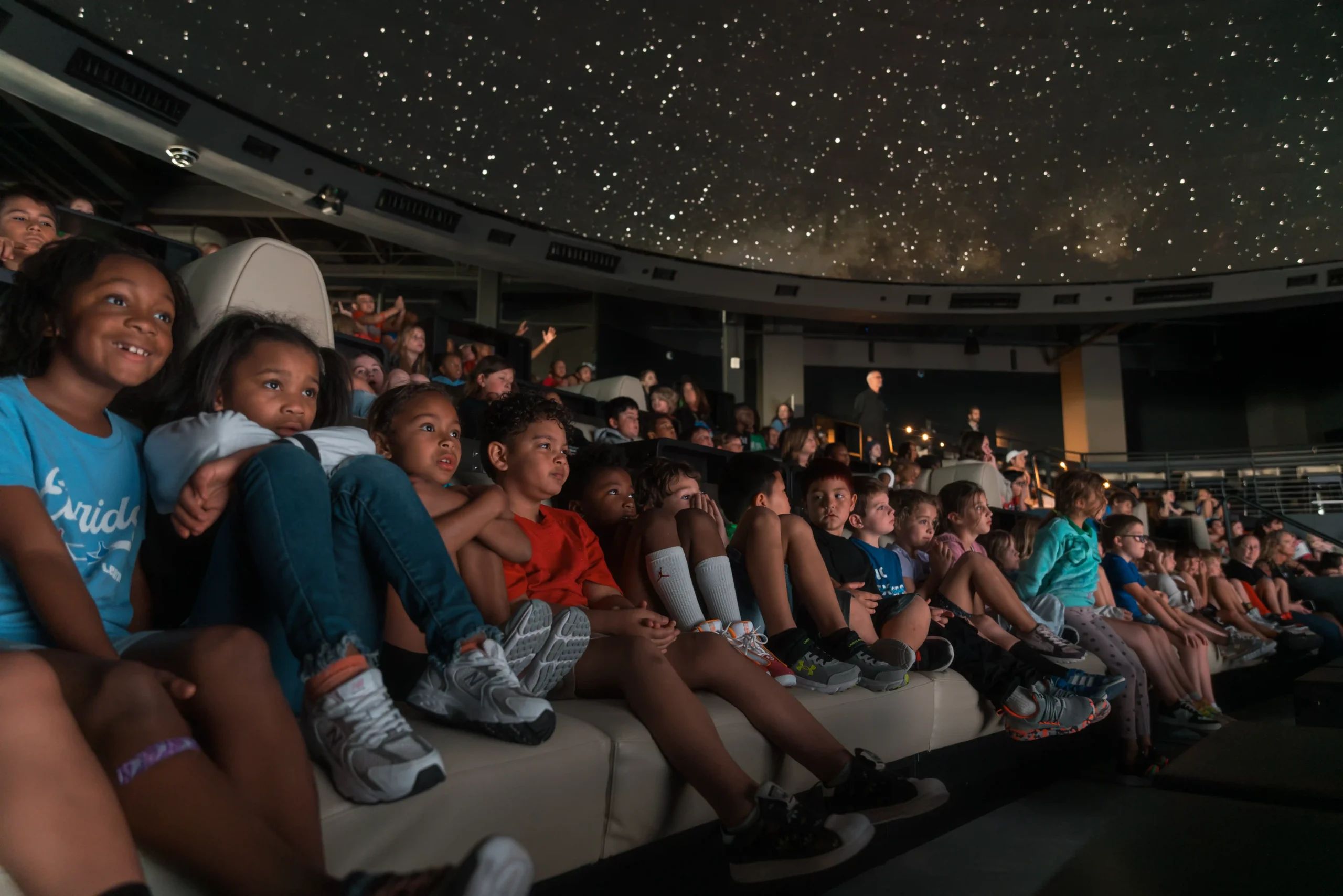 Students enjoying a Cosm immersive venue field trip