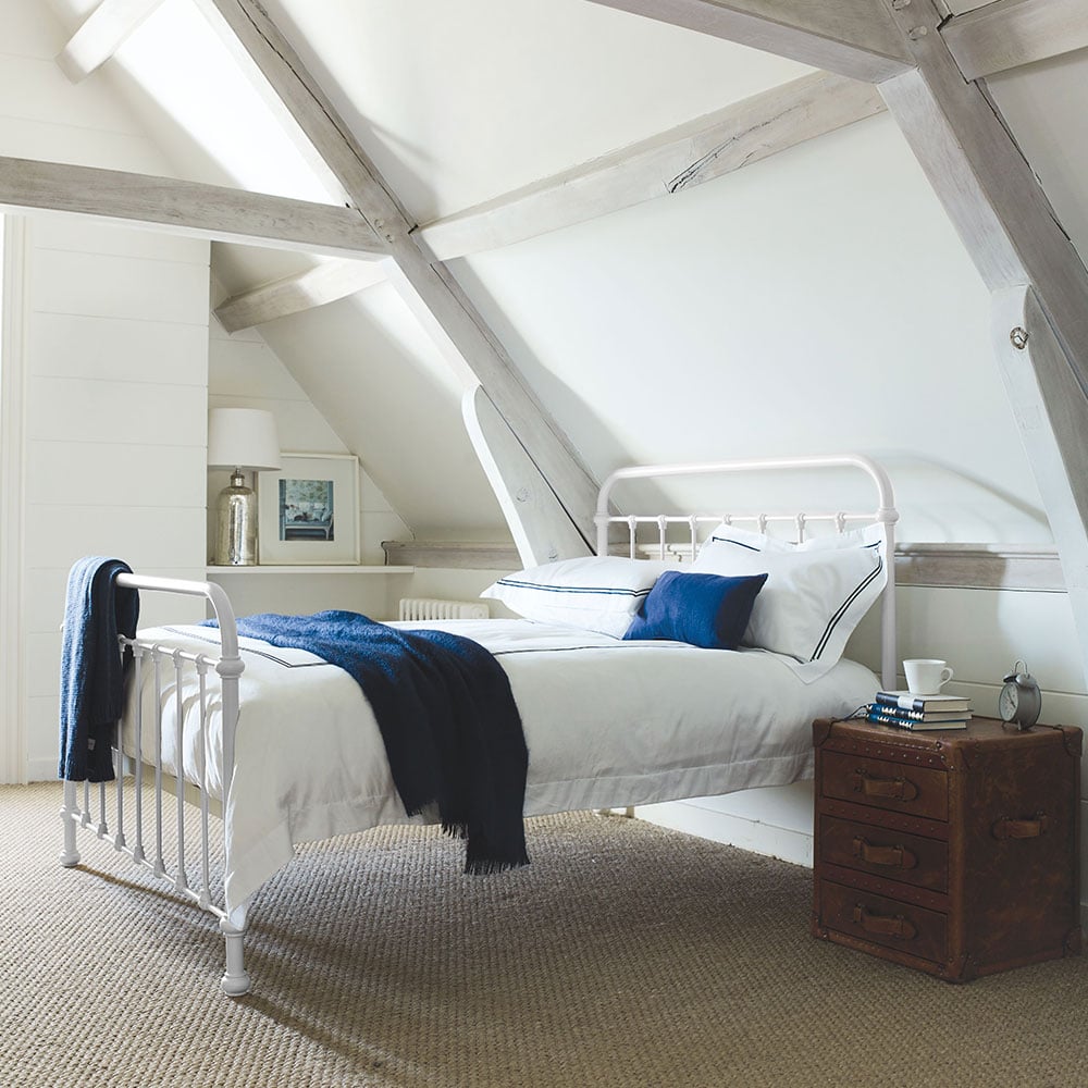 Oliver porcelain white metal bed in a bedroom