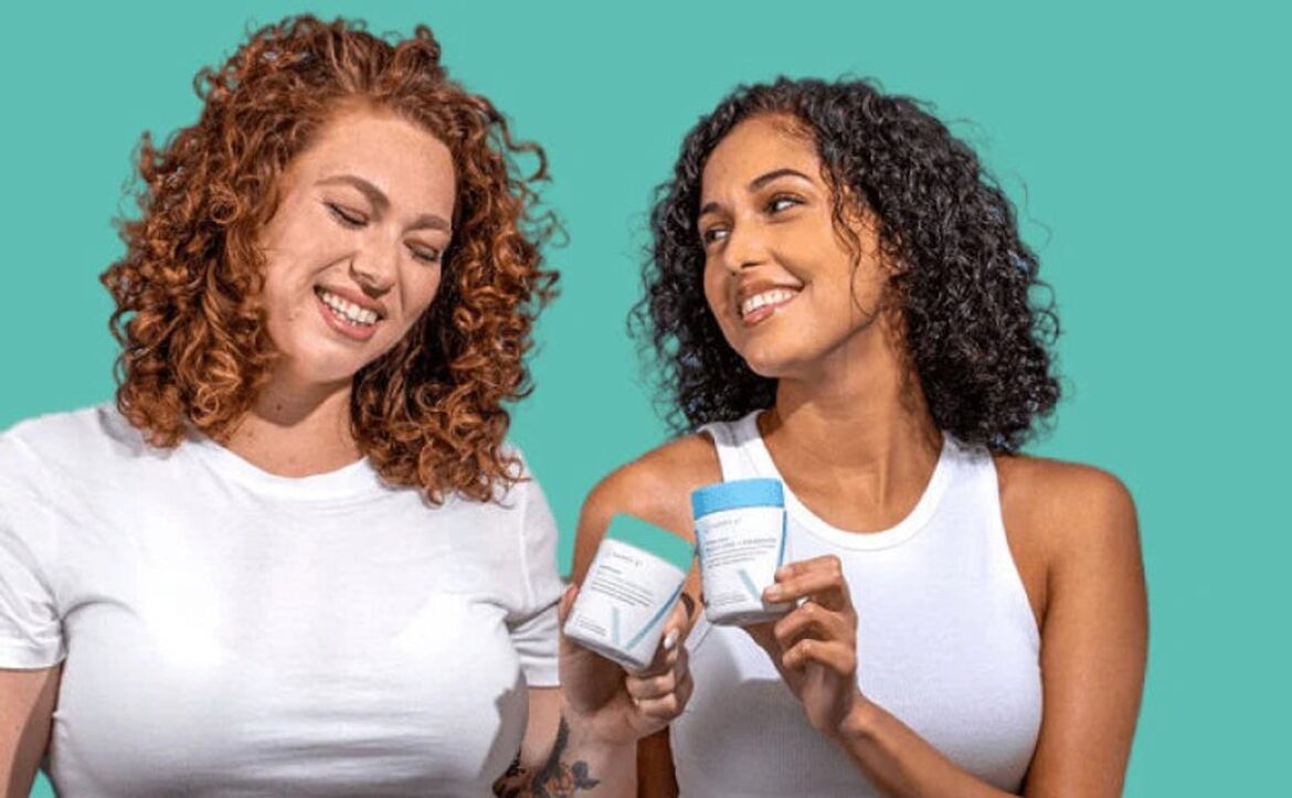 Two women holding Happy V wellness products in a bright lifestyle scene