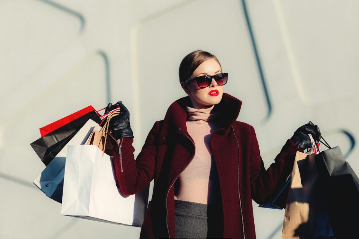 Woman holding shopping bags in a bright fashion setting