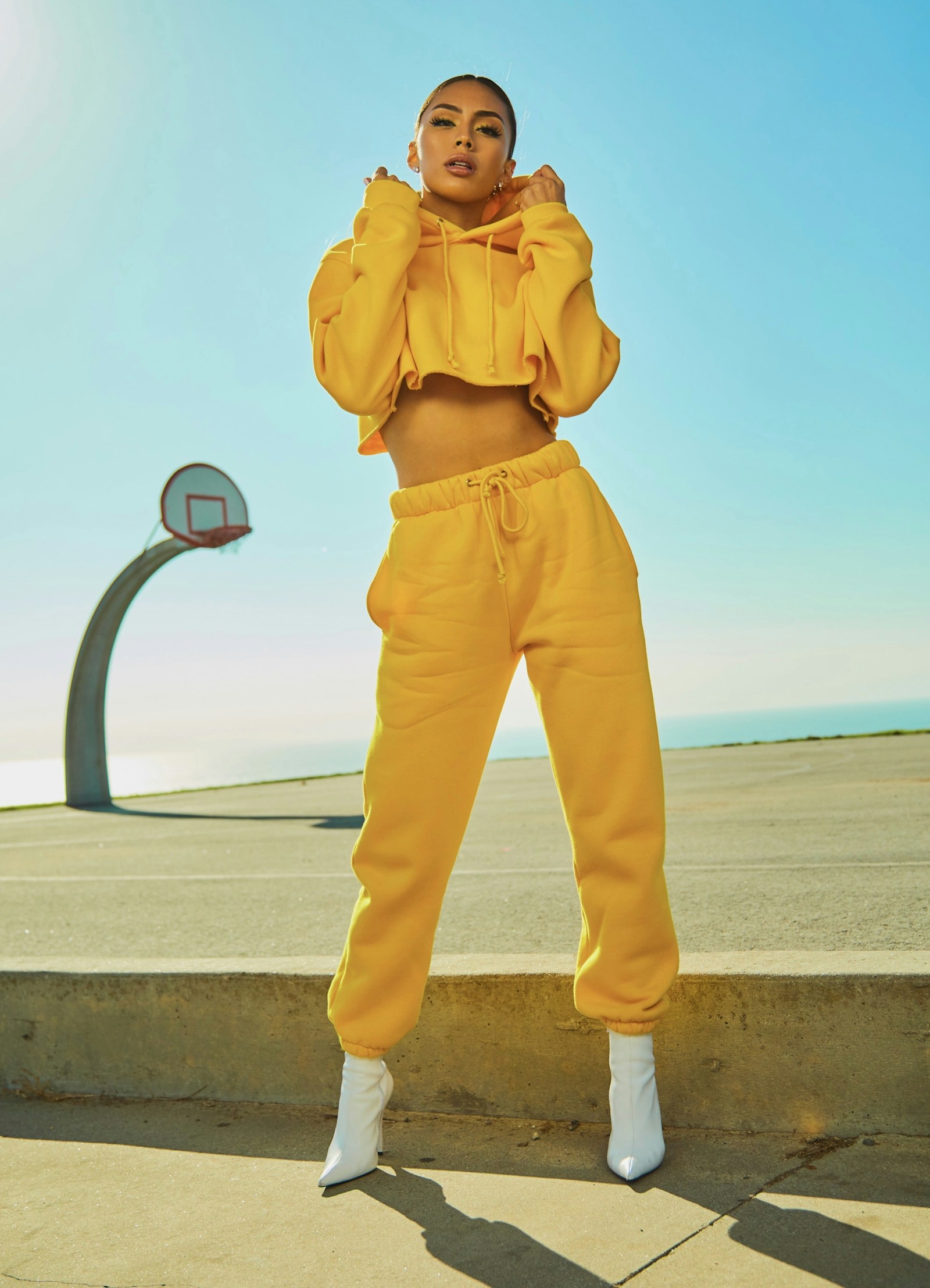 Model wearing a yellow tracksuit outdoors