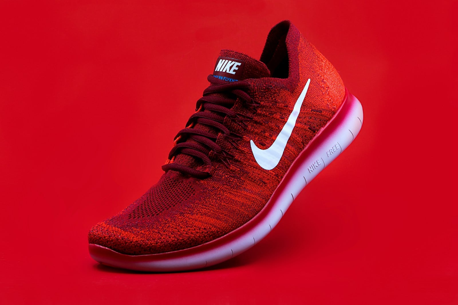 Red fashion sneaker shown in a clean product-style scene