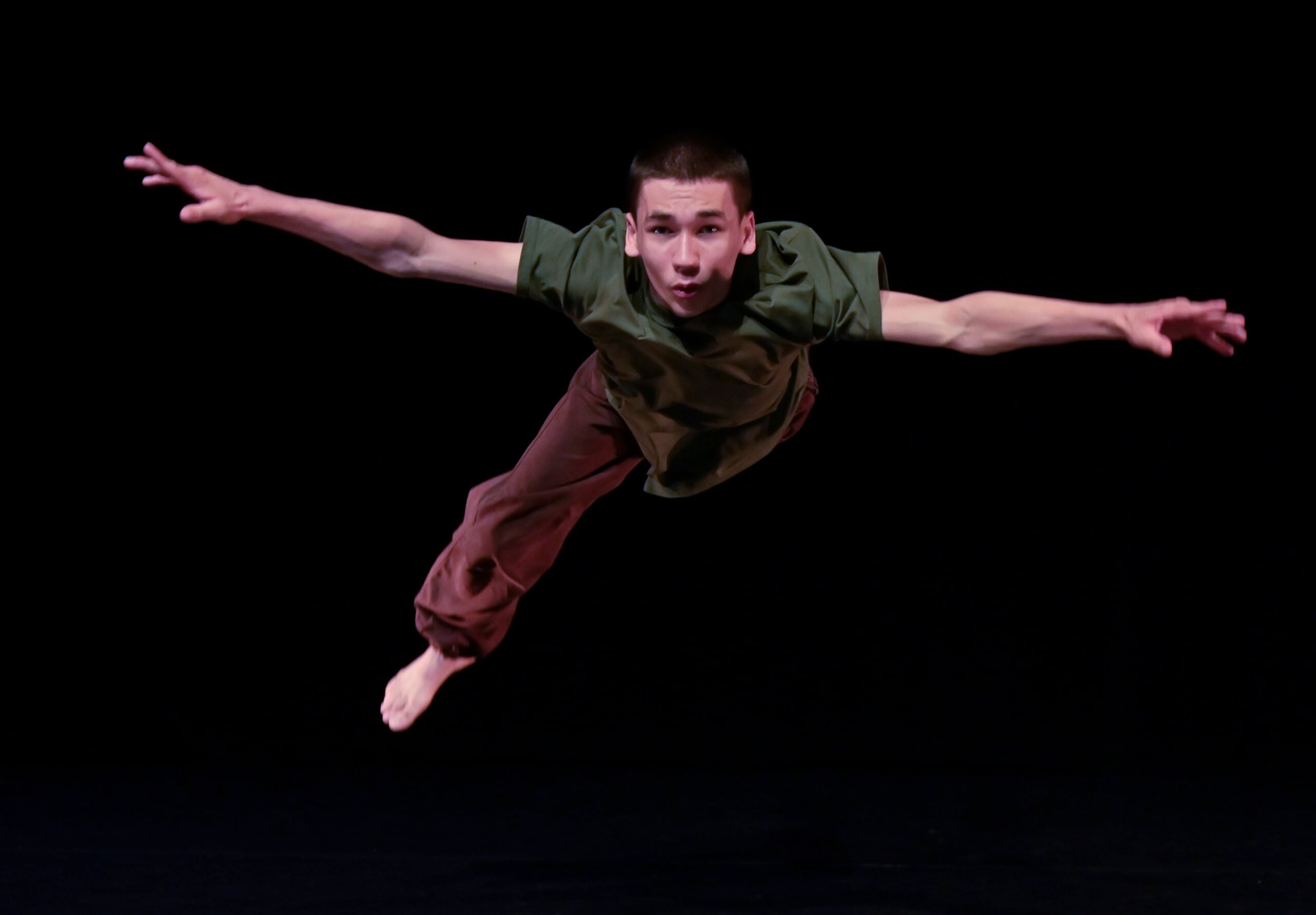 Solo dancer on a black stage at Lowry