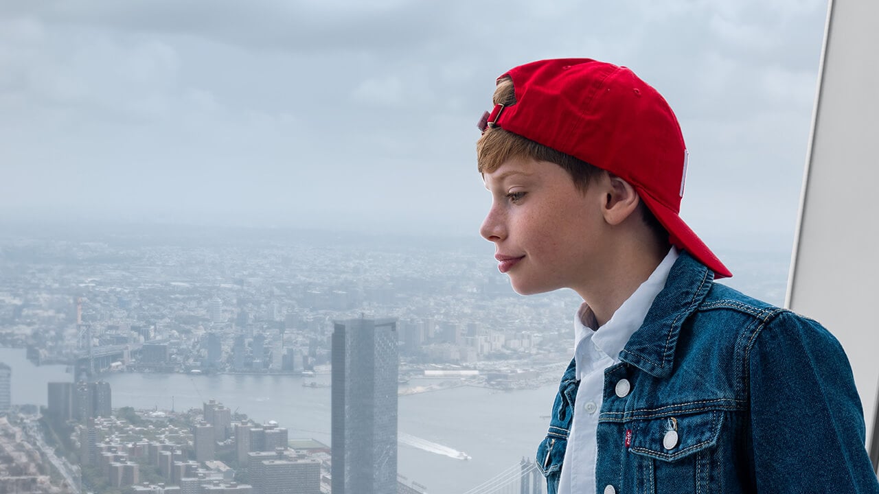 Visitors taking in the Manhattan skyline inside One World Observatory