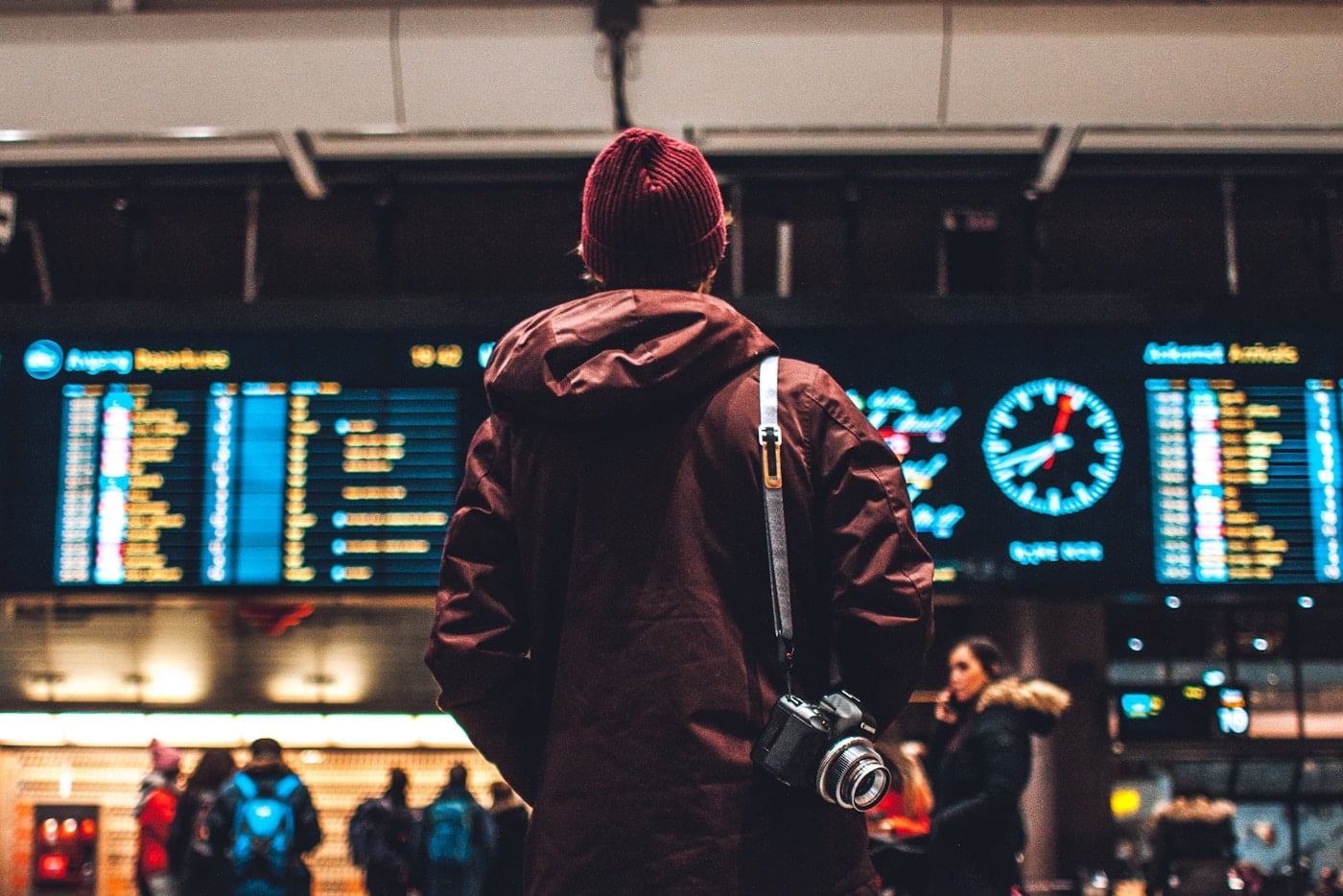 Travellers moving through a bright airport terminal