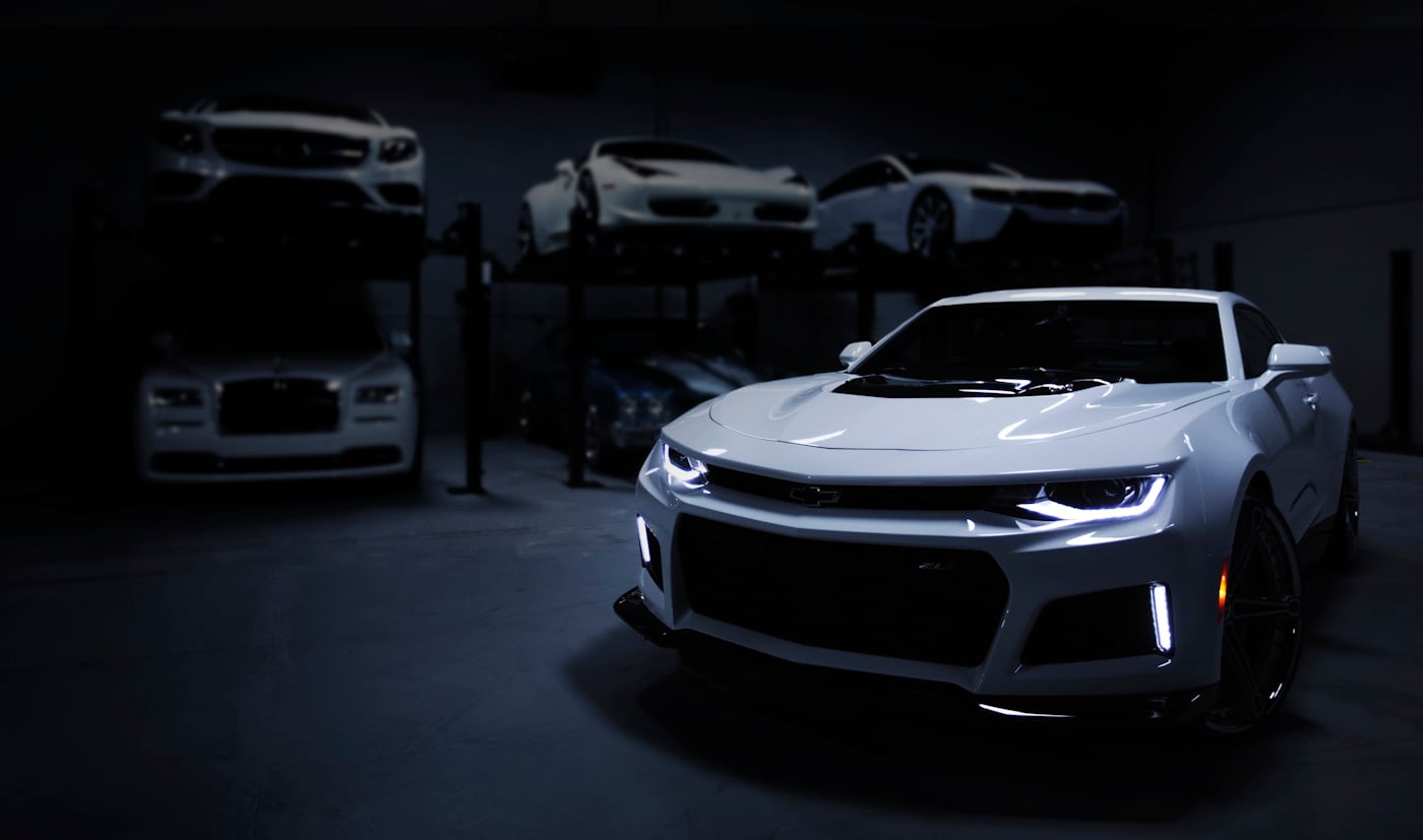White sports car in a dark garage