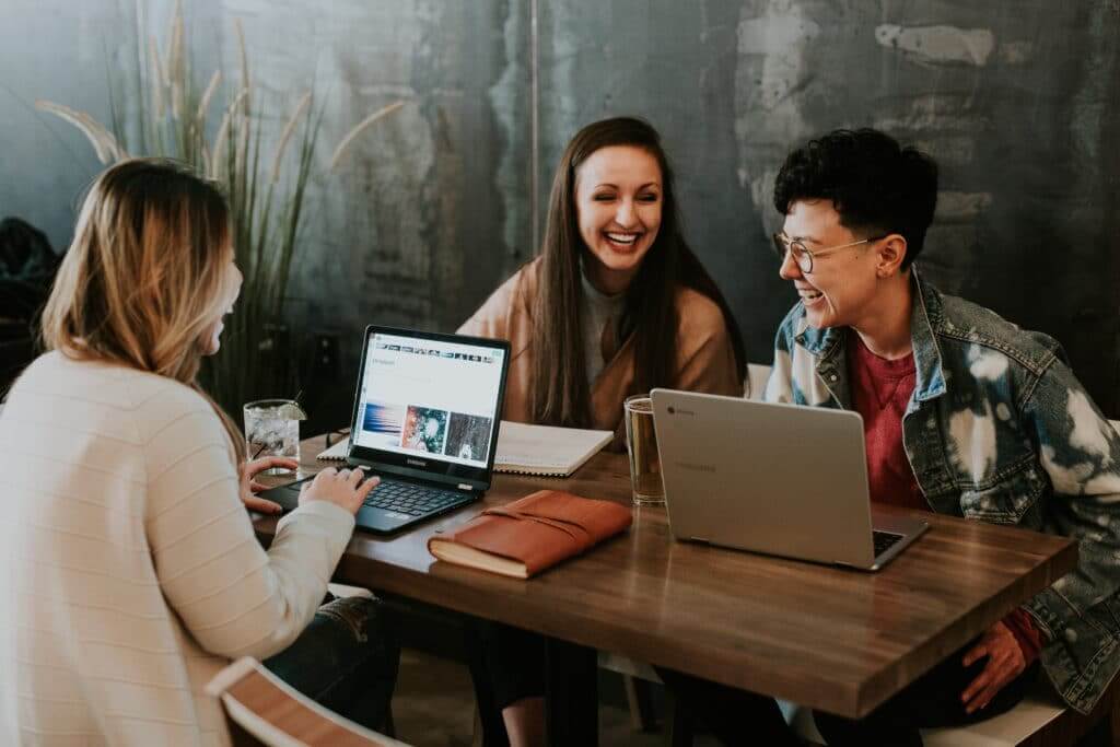 People working at laptops in an event-planning scene
