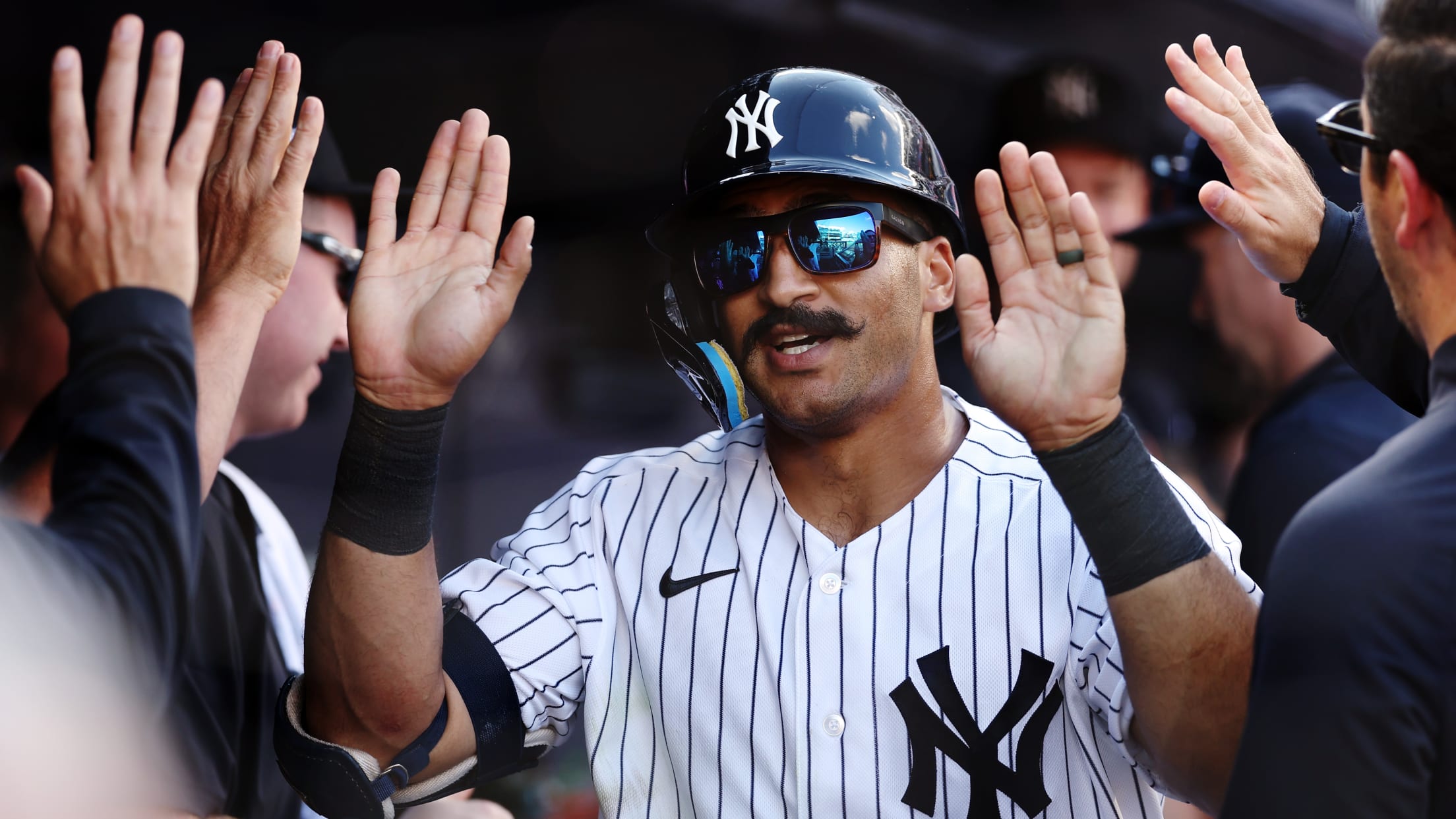 Yankees player high-fiving teammates