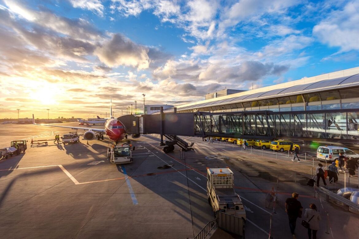 Airport terminal and aircraft seen across the apron