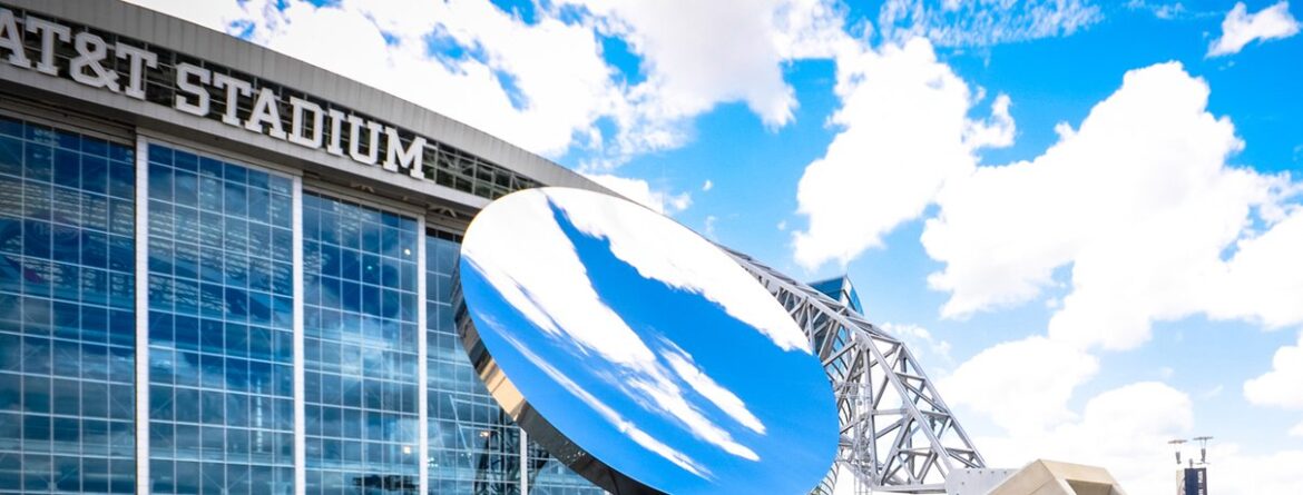 AT&T Stadium exterior with the Sky Mirror reflecting blue sky and clouds
