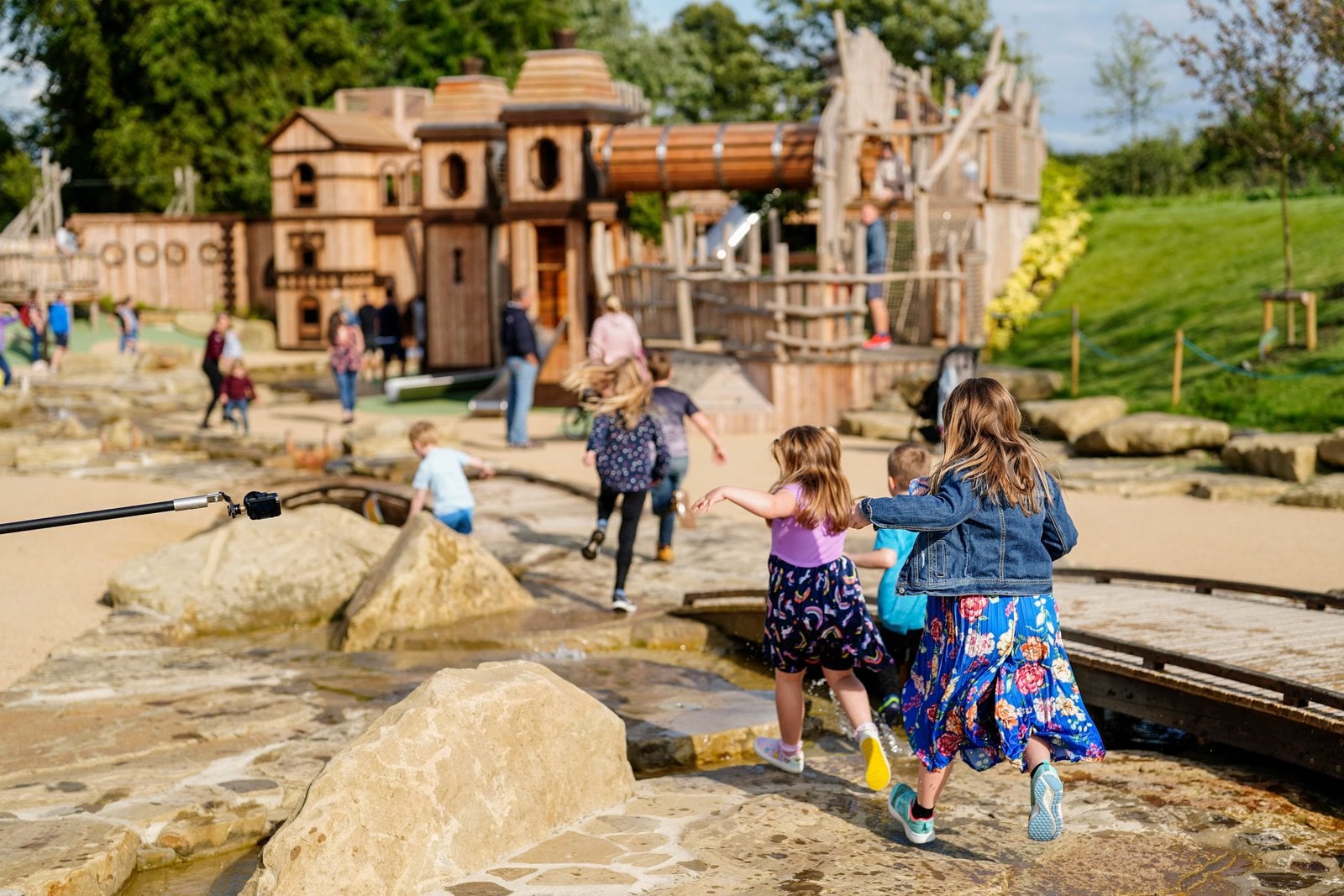 Children playing across the outdoor Adventure Play structures at Blenheim Palace