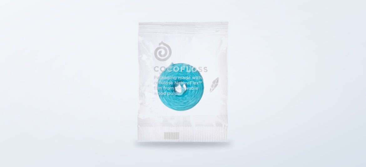 Cocofloss eco-friendly refill spool on a gray background
