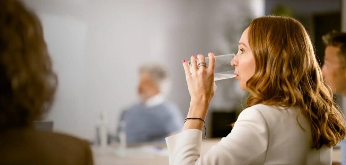 Woman drinking water at work