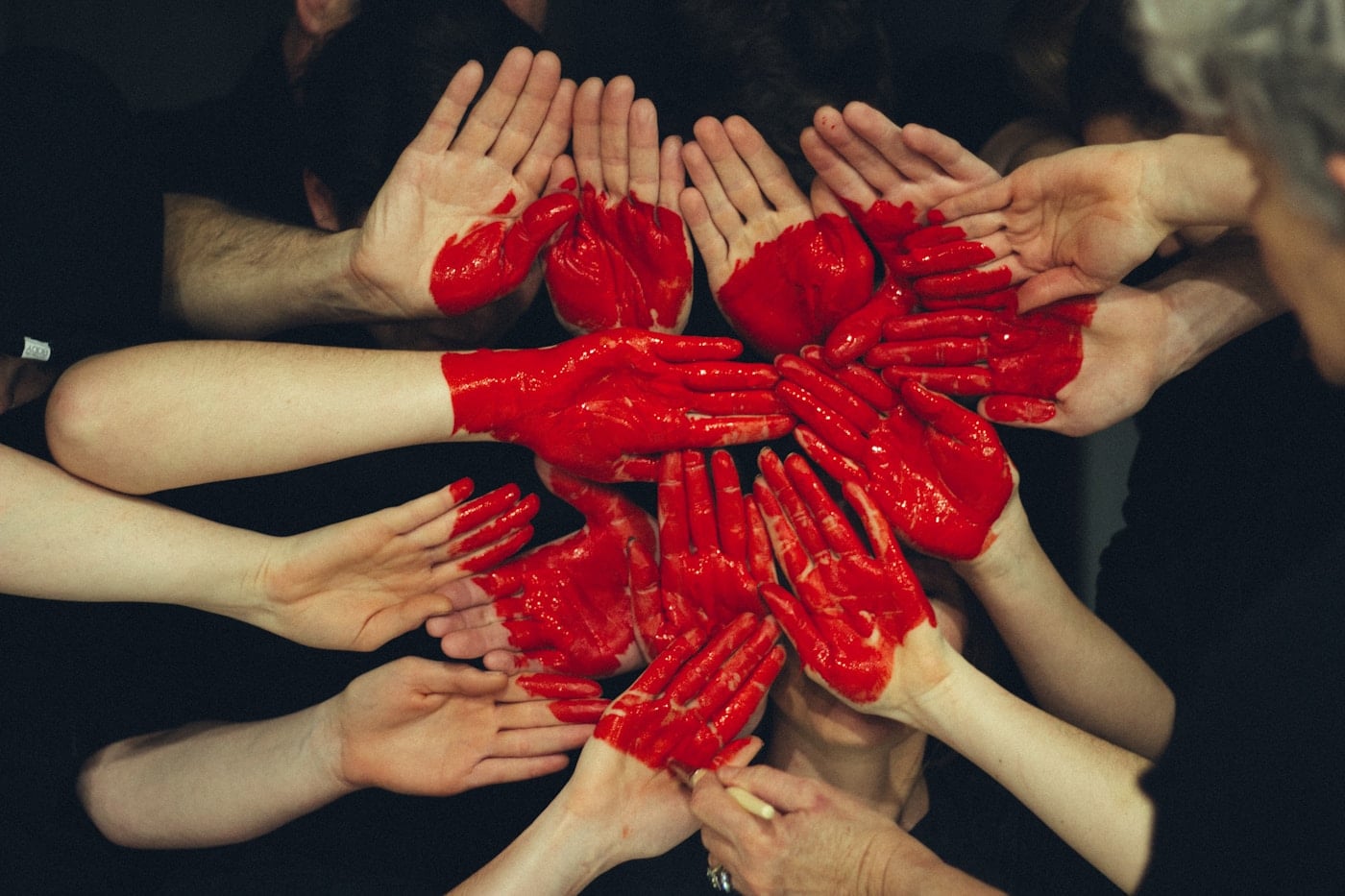 Hands covered in red paint