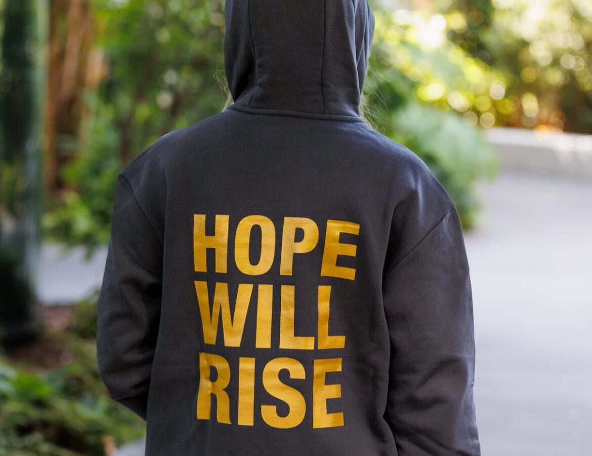 Hope Will Rise hoodie from Hunger Games on Stage styled for a casual look