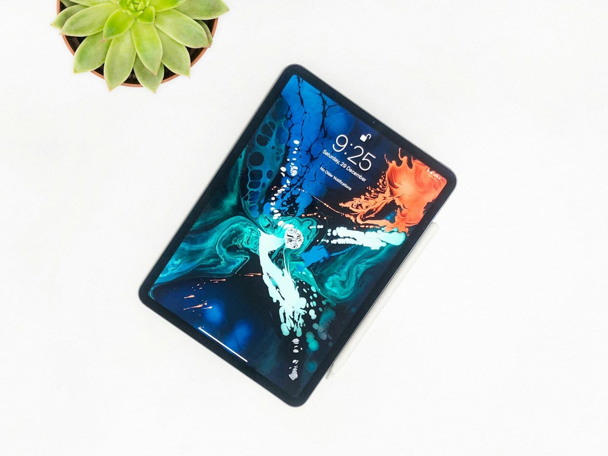 Tablet beside a plant