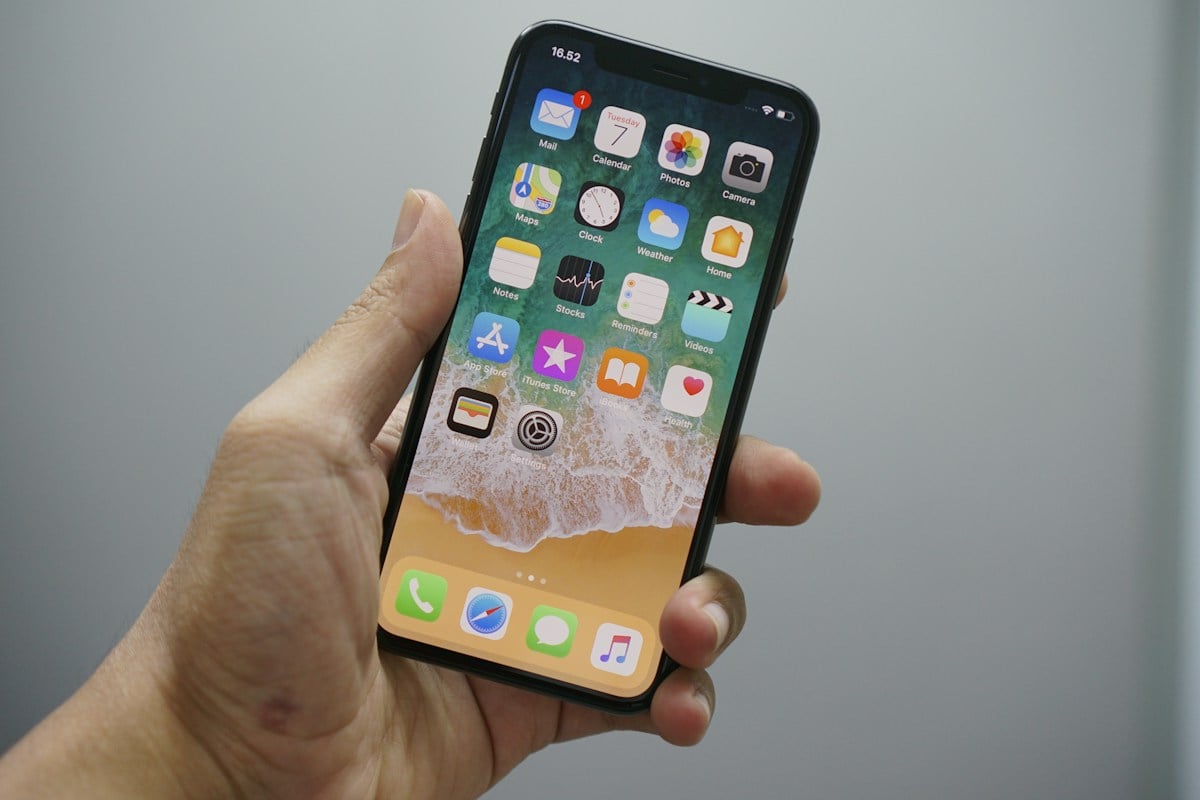 Hand holding an iPhone