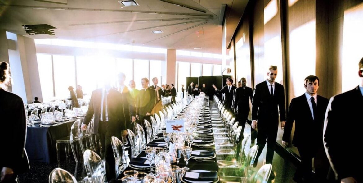Guests at a long table beside the windows at One World Observatory