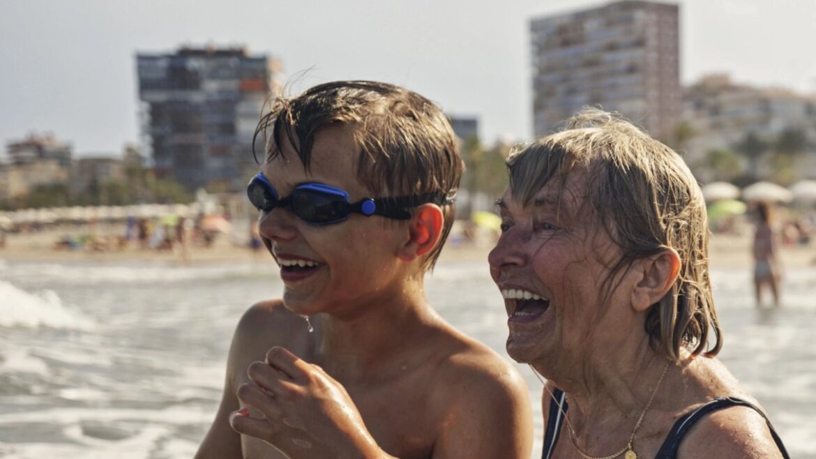 Boy and older woman swimming at the beach