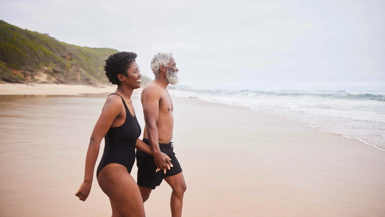 Older couple holding hands outdoors