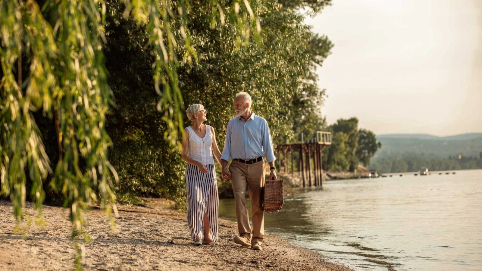 Mature couple strolling beside a river