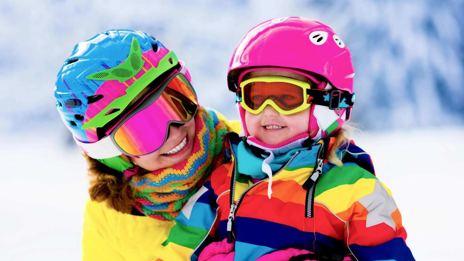 Two people in colourful ski clothing outdoors
