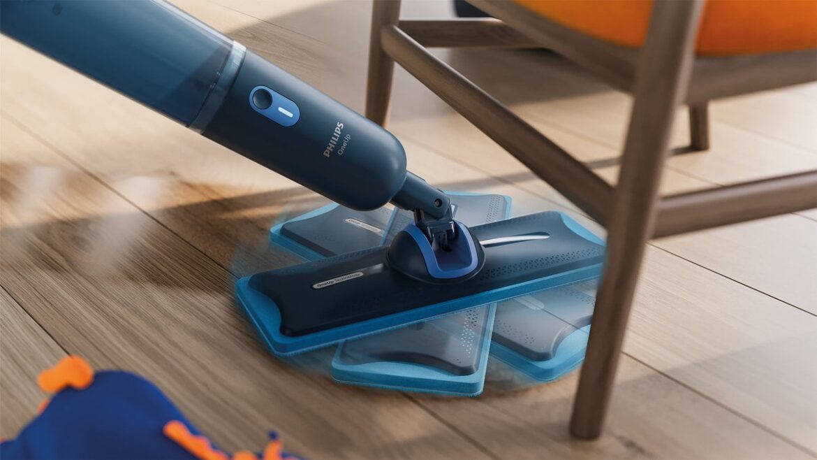Philips OneUp cordless mop cleaning a wooden floor under a chair