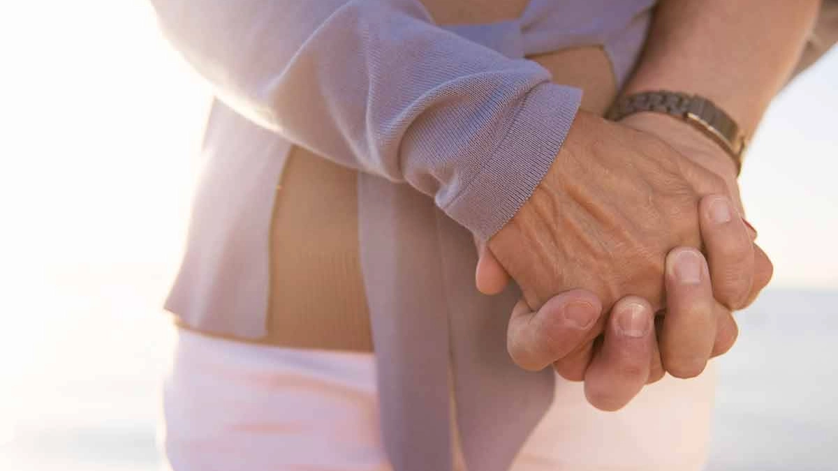 Clasped hands in sunlight