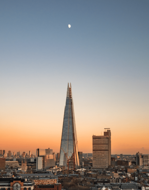 Sunset view of The Shard with the moon above London
