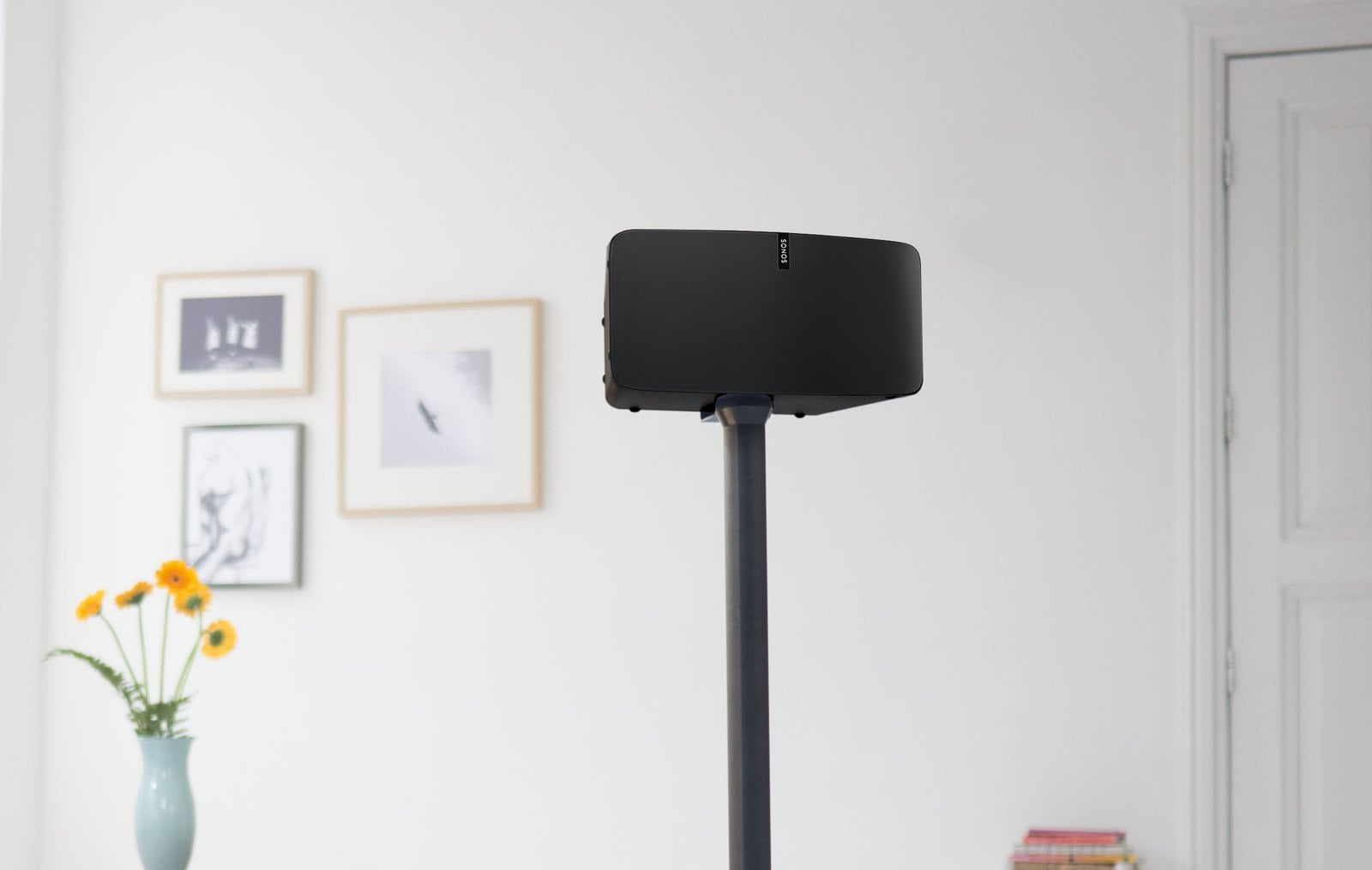 Compact speakers mounted in a modern living room