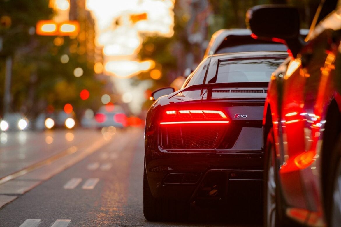 Sports car travelling through city traffic