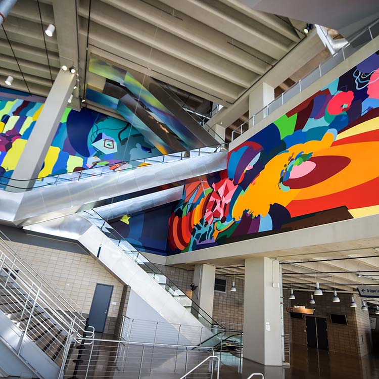 Visitors viewing artwork during the AT&T Stadium Art Tour