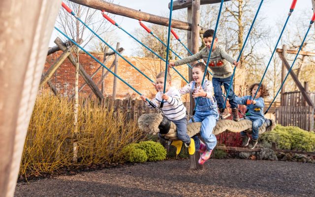 Children exploring an outdoor play structure at Adventure Play