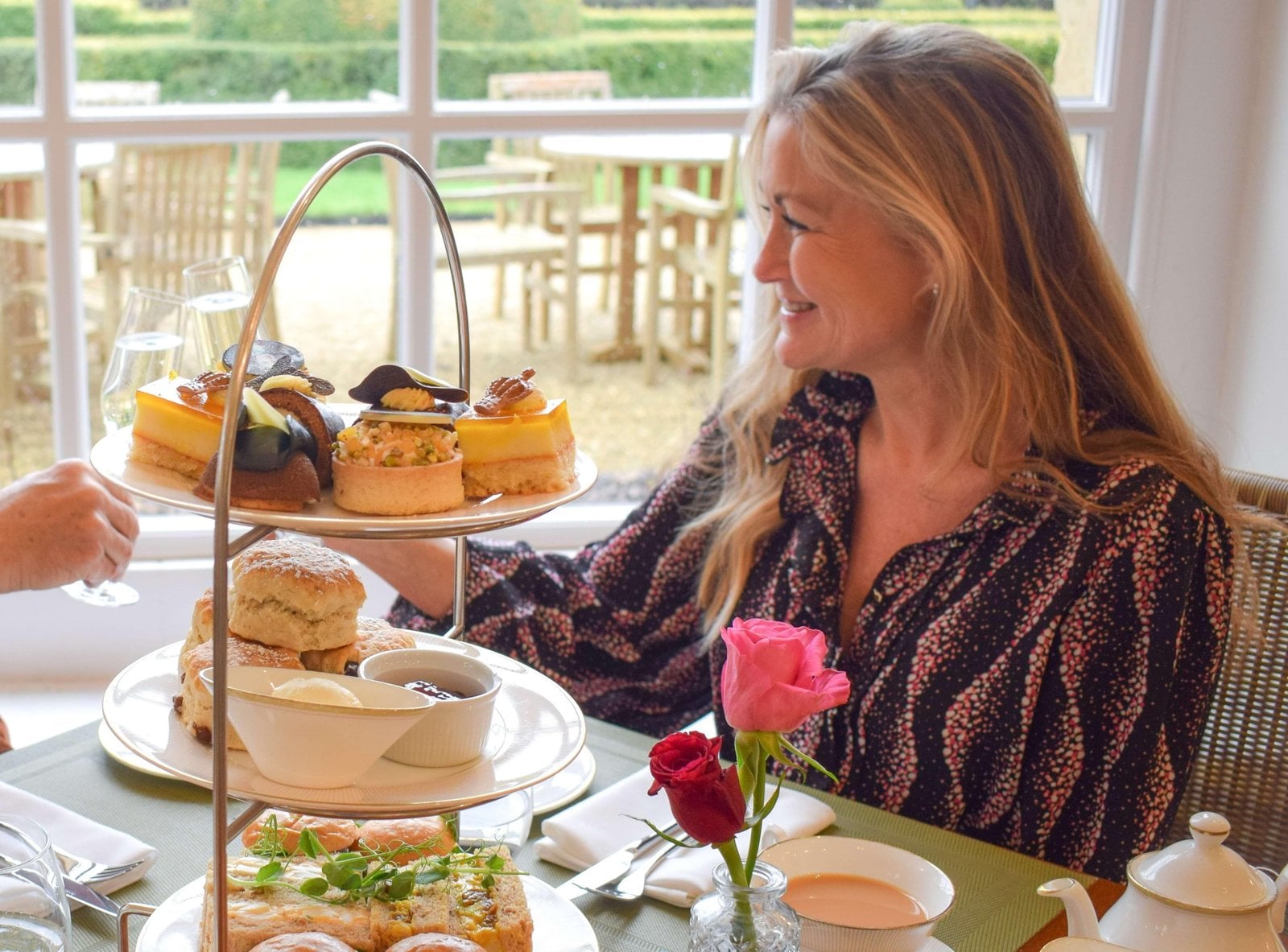 Afternoon tea stand beside glasses at Blenheim Palace