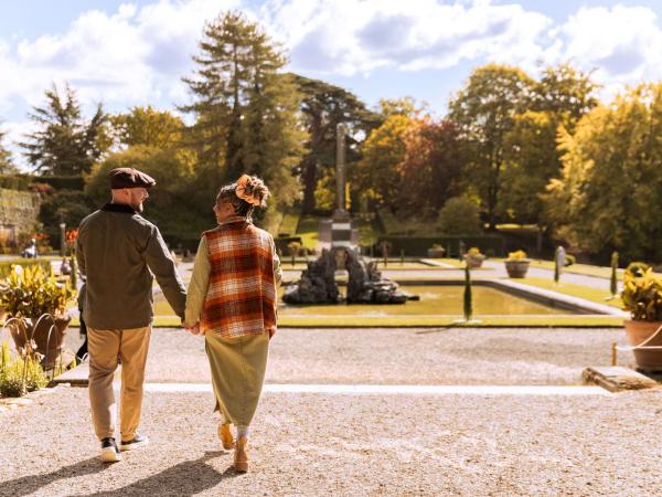 Visitors walking through autumn grounds at Blenheim Palace