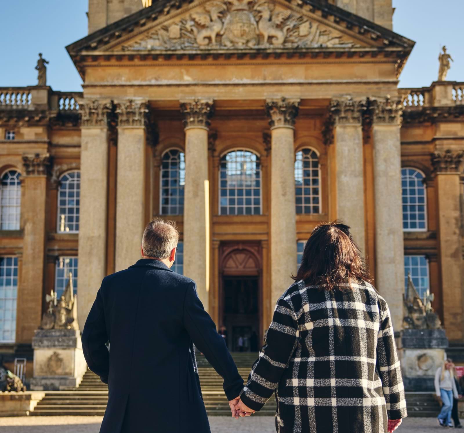 A couple walking towards Blenheim Palace