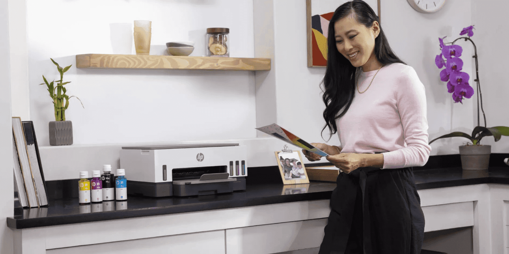 HP Smart Tank printer and refillable ink bottles on a kitchen counter