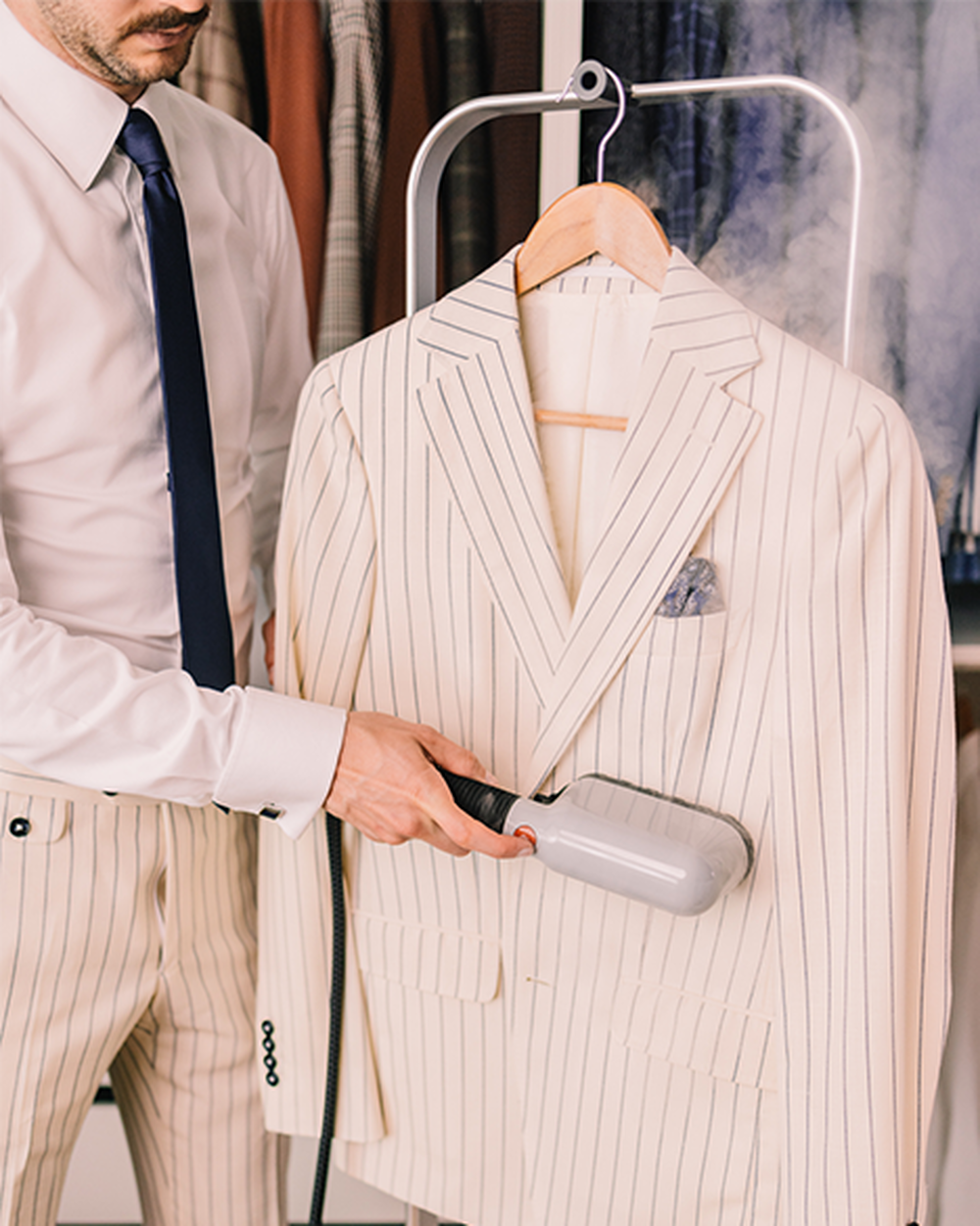 A person steaming a jacket with Laurastar IZZI