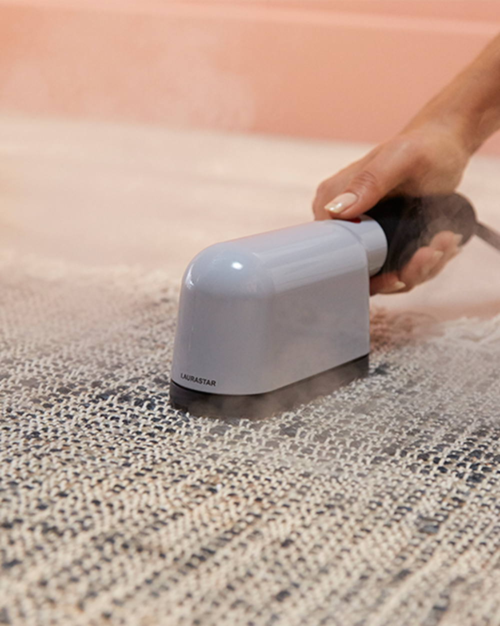 Laurastar IZZI being used on a textured fabric surface