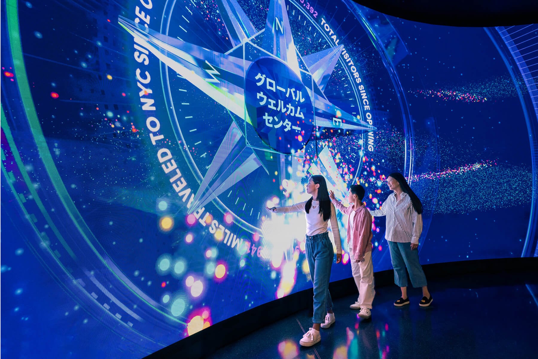 Visitors at the Global Welcome Center wall