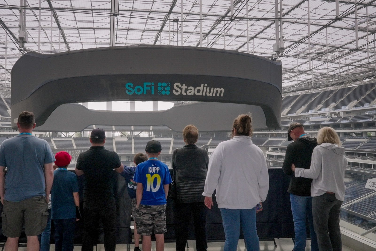 Tour visitors looking toward the SoFi Stadium video board