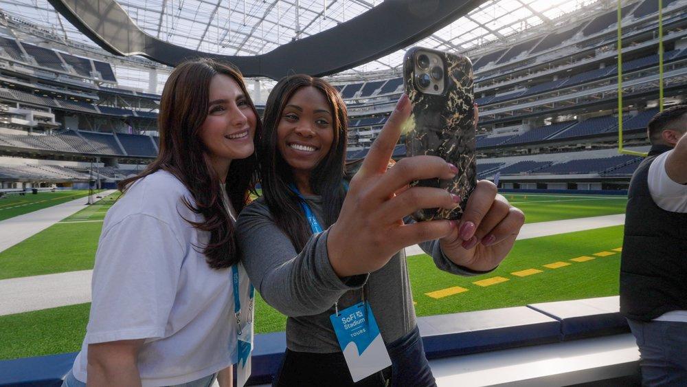 Visitors taking a selfie on the stadium field