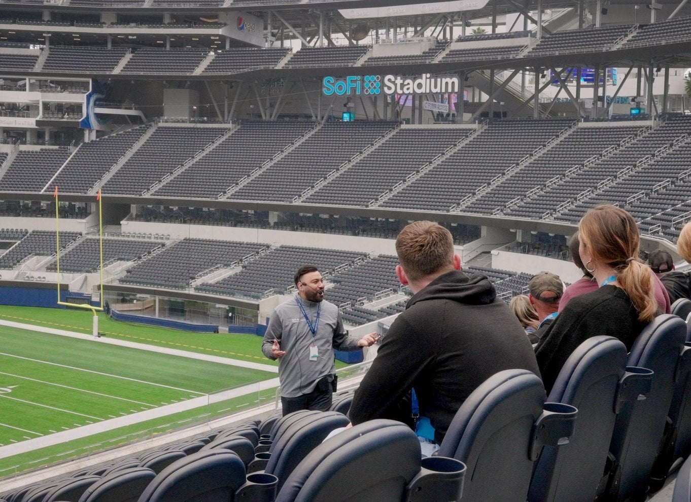 Guide speaking to tour guests inside SoFi Stadium