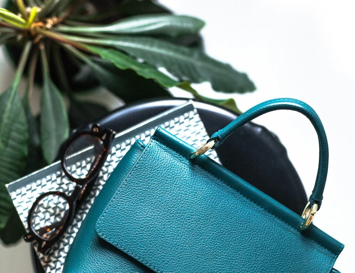 Teal leather handbag in a fashion setting