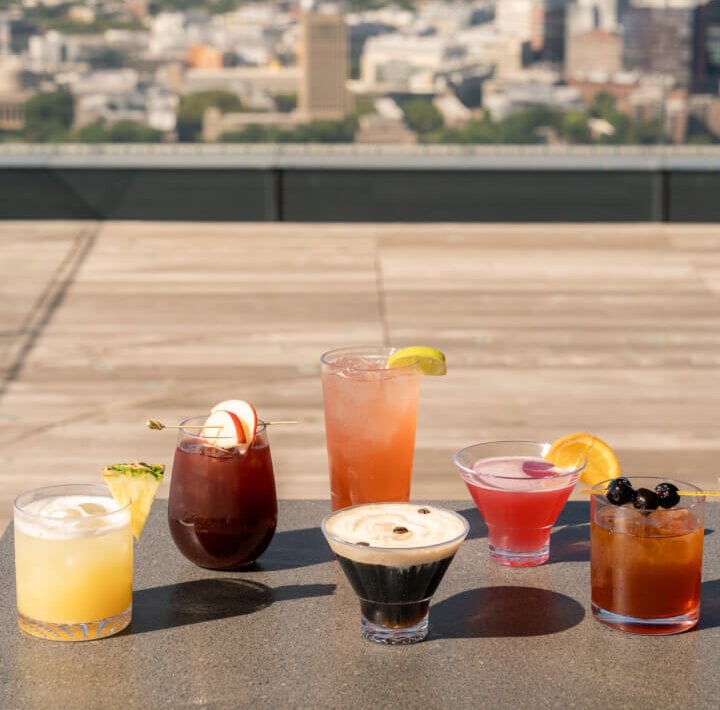 Cocktails on a rooftop ledge at Stratus Rooftop Bar