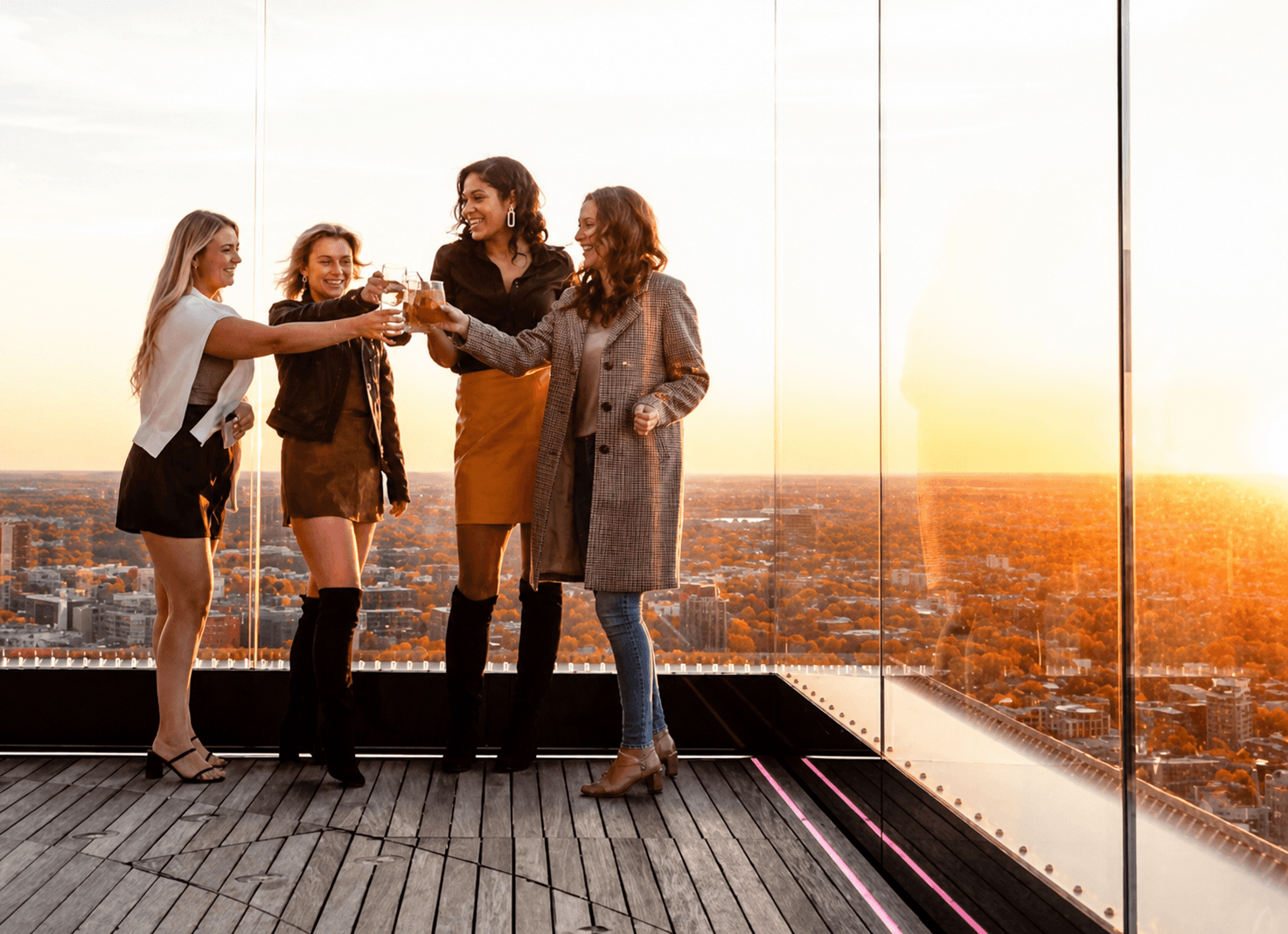 Four guests toasting at View Boston